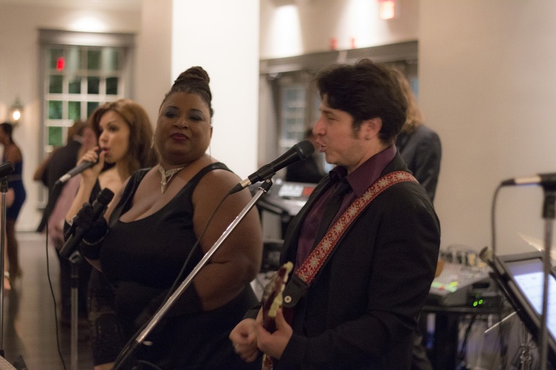 Six-piece band with horns at a wedding reception
