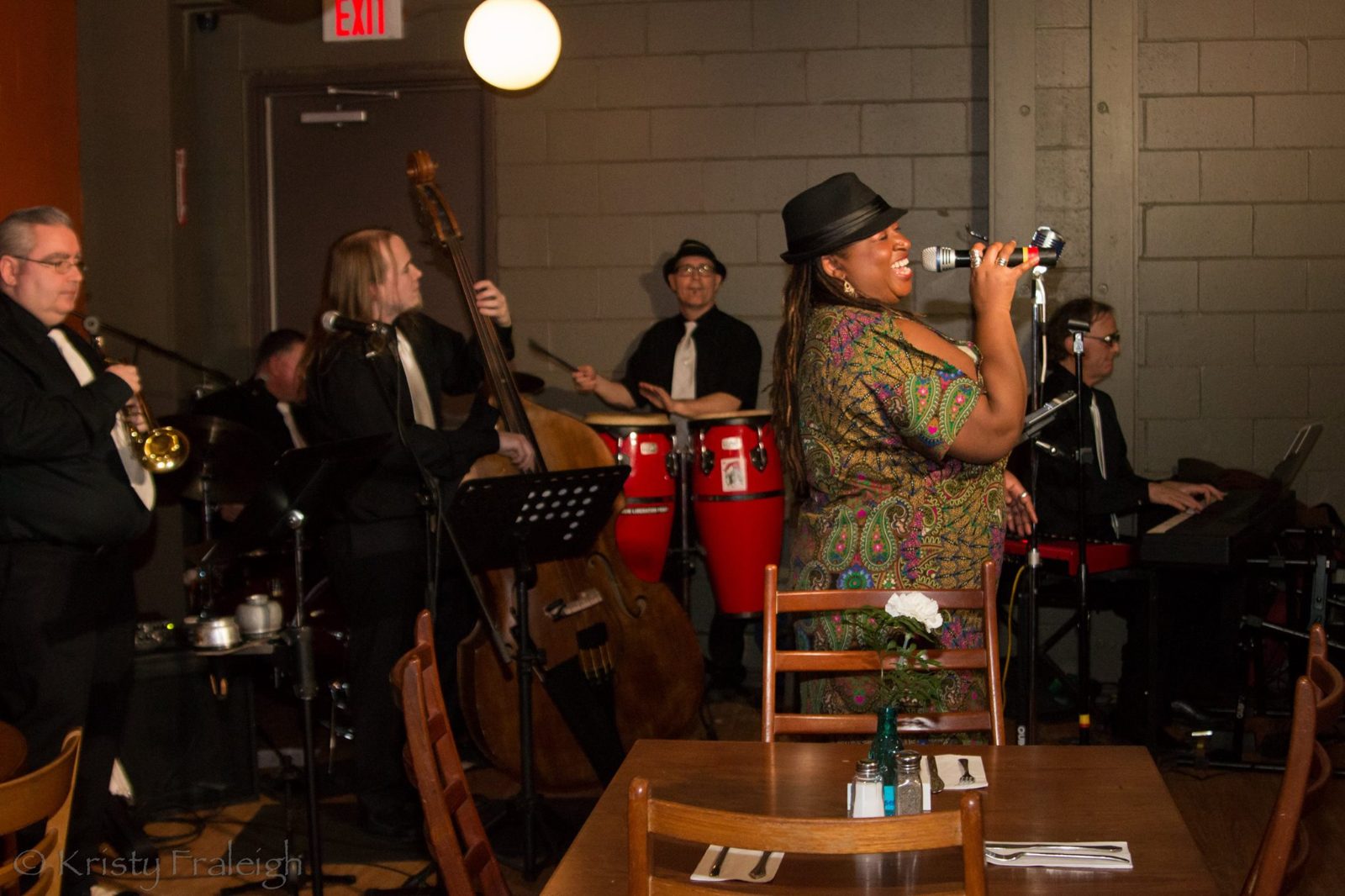 Carolyn T fronting the band with trombone, upright bass and congas
