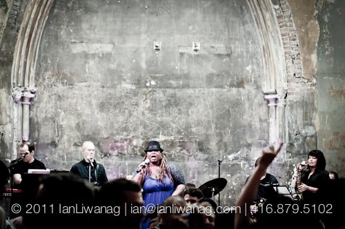 Carolyn T with the band and saxophone at a cathedral venue